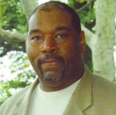 Bert Girigorie's potrait photo wearing yellow coat and white t-shirts. 